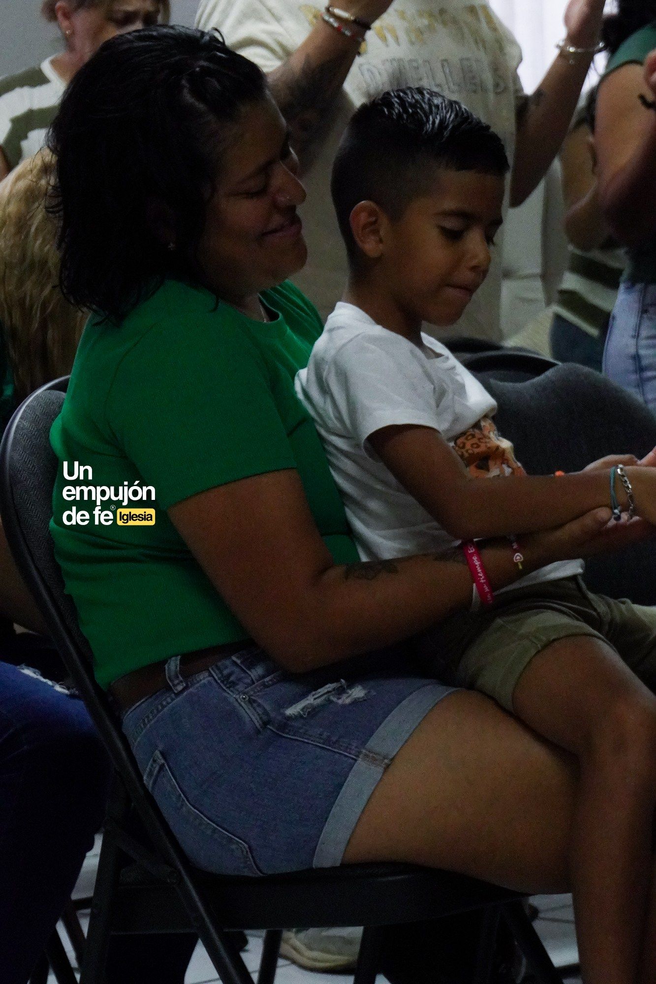Una mamá con su hijo en brazos durante la reunión del domingo
